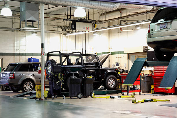 Véhicules tout-terrain Land Rover en réparation dans un garage spécialisé